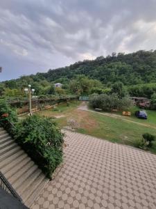 a view of a park with a hill in the background at Guesthouse at Oleg's Zolotoy Bereg in Gudauta