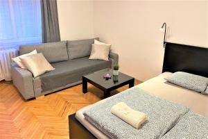 a living room with a couch and a bed at Apartment Helen - Old Town, AC in Bratislava