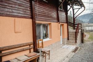 a building with a window and a bench next to it at Cabana Yvan in Gârda de Sus +12 photos