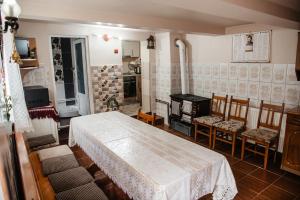 a room with a bed and chairs and a fireplace at Cabana Yvan in Gârda de Sus