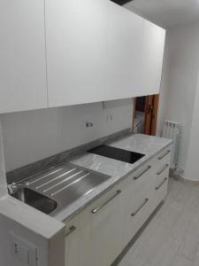 a white kitchen with a sink and a counter top at Pria de Mar 2 nuovo da giugno 2022 in Riomaggiore