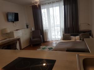 a living room with a couch and a tv at Apartament Elbląg Stare Miasto - Old Town in Elblag