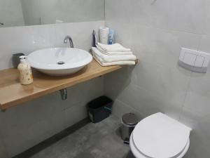 a bathroom with a white sink and a toilet at Apartament Elbląg Stare Miasto - Old Town in Elblag