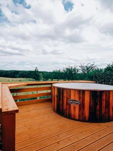 a wooden tub sitting on a wooden deck at Crabmill Glamping with hot tub in Bewdley