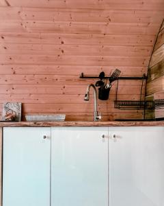 a kitchen with white cabinets and a sink at Crabmill Glamping with hot tub in Bewdley