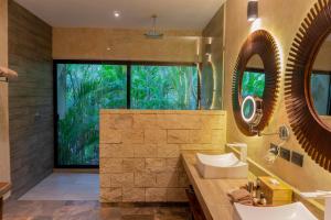 a bathroom with a sink and a mirror at Aldea Coba An Escape Boutique Experience in Coba
