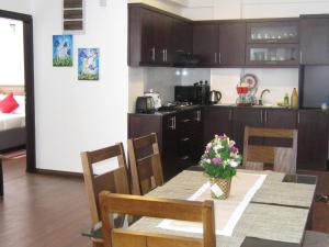 a kitchen and dining room with a table and chairs at Chanya Luxury Apartment, S 31, Lake View Residencies in Nuwara Eliya