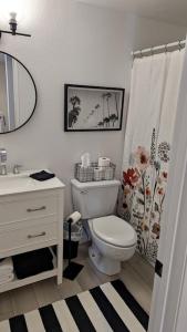 a bathroom with a toilet and a shower curtain at Cozy condo walking distance to village and gondola w/ pool/ jacuzzi sleeps 4. in Mammoth Lakes