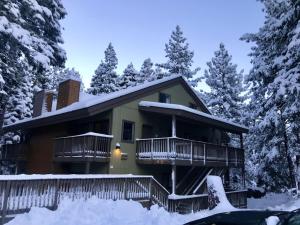 a house covered in snow with snow covered trees at Cozy condo walking distance to village and gondola w/ pool/ jacuzzi sleeps 4. in Mammoth Lakes