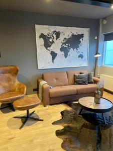 a living room with a couch and a table at Lovely apartment with hot tub access in Akureyri