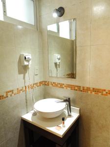 a bathroom with a sink and a mirror at Hotel River Poliforum in León