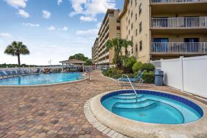 a swimming pool in front of a building at Bayshore Yacht & Tennis 216 in Clearwater Beach
