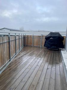 an empty deck with a black bag on a roof at Lovely apartment with hot tub access in Akureyri