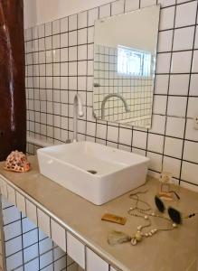 a white sink in a bathroom with a mirror at Ladha ya Zanzibar Boutique Guesthouse in Jambiani