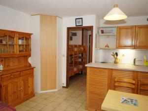a kitchen with wooden cabinets and a counter top at Studio Samoëns, 1 pièce, 4 personnes - FR-1-629-117 in Samoëns
