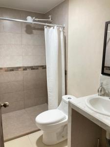 a bathroom with a toilet and a shower and a sink at Hospedaje Ana Lu 2, Only 10 minutes from airport in Alajuela City +19 photos