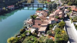 an aerial view of a village next to a river at @LaCasettasulFiume in Sarnico