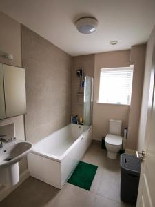 a bathroom with a tub and a sink and a toilet at Cozy room in Lucan in Lucan