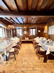 a dining room with white tables and chairs at Hotel Grünwalderhof in Innsbruck