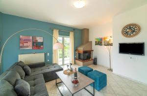 a living room with a couch and a table at Chania City Villa in Mourniaí