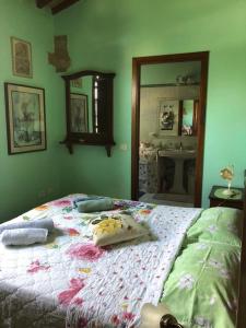 a bedroom with a large bed with a mirror at Country House Girasole Crete Senesi Vakantie Huis in Asciano