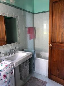 a bathroom with a sink and a bath tub at Country House Girasole Crete Senesi Vakantie Huis in Asciano