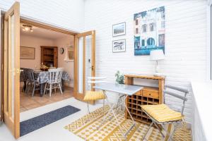 a room with a table and chairs and a dining room at Staithe View by Big Skies Cottages in Burnham Deepdale