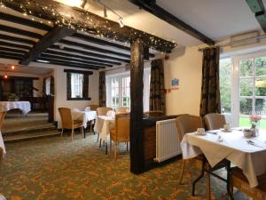 a dining room with white tables and chairs at Marston Farm Hotel in Sutton Coldfield +26 photos