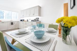 a kitchen with a table with a blue bowl on it at The Lookout in Wells next the Sea