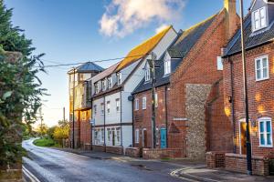 a row of brick buildings on a street at The Lookout in Wells next the Sea