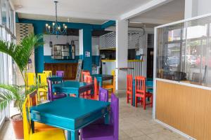 un restaurante con mesas y sillas coloridas en Hotel Las Colinas, en Fortuna