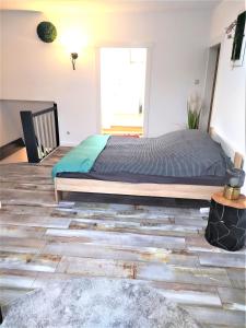 a bedroom with a bed and a wooden floor at schöne geräumige ganze Wohnung als Unterkunft in Bergen