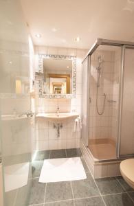 a bathroom with a shower and a sink at Hotel St. Nikolaus in Ischgl