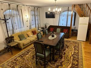 a living room with a table and a couch at Casa de vacanta Mirela in Novaci-Străini +25 photos