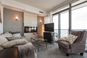 a living room with a couch and a tv at Stunning condo with fantastic view of the city! in Toronto