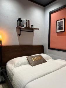 a bedroom with a bed with a brown pillow on it at ZUSCH STUDIO in Pantai Cenang