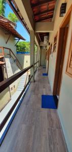 an empty hallway of a building with blue mats on the floor at Pousada Sakura Rio Mar in Abraão +15 photos
