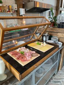 two plates of meat on a counter in a kitchen at De Zuileshoeve in Dordrecht