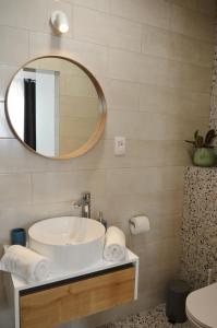 a bathroom with a sink and a mirror at Mediterra 1 in Crikvenica