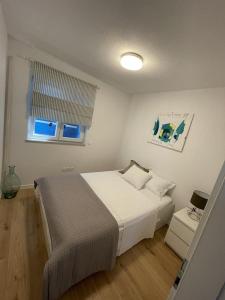 a bedroom with a large bed and a window at Island Brac - Villa Vita in Nerežišće