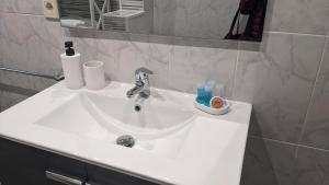 a white sink in a bathroom with a mirror at Arran de Mar Cambrils in Cambrils +13 photos