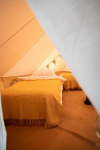 a bedroom with a bed in an airplane at Nine Yards Bell Tents @ The Open in West Kirby
