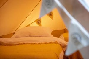 a bedroom with a bed in a tent at Nine Yards Bell Tents @ The Open in West Kirby