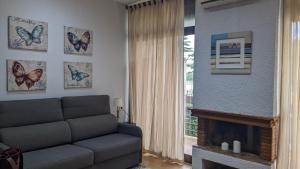 a living room with a couch and a fireplace at Arran de Mar Cambrils in Cambrils