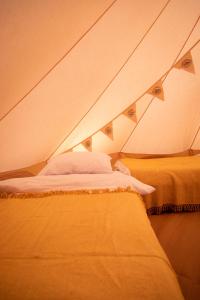 a room with two beds in a tent at Nine Yards Bell Tents @ The Open in West Kirby