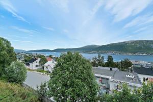 a view of a town with a body of water at Modern apartment in the center of the island in Tromsø