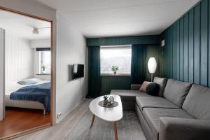a living room with a couch and a bed at Modern apartment in the center of the island in Tromsø