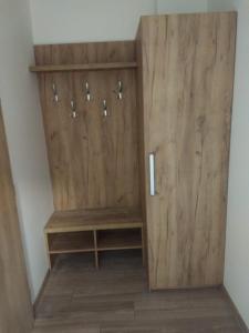 a closet with wooden doors in a room at Apartman Emma in Liptovský Ján +3 photos