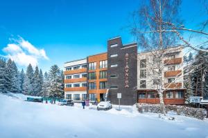 a building with snow in front of it at Apartman Emma in Liptovský Ján