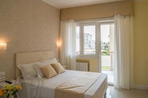 a bedroom with a bed and a large window at Guest House Train Station in Mestre